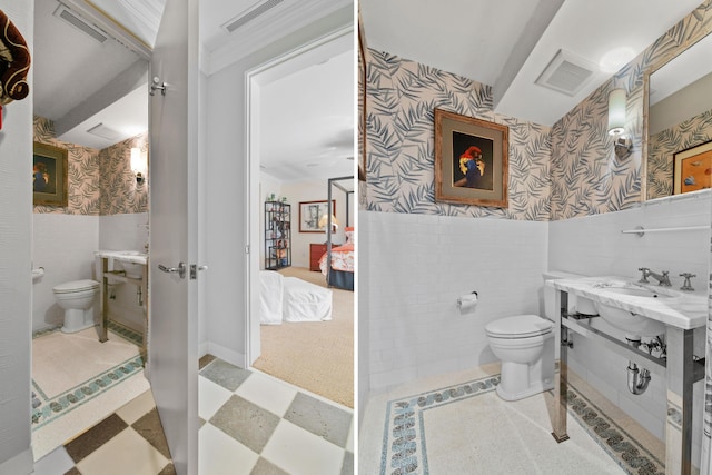 bathroom with vanity, tile walls, and toilet