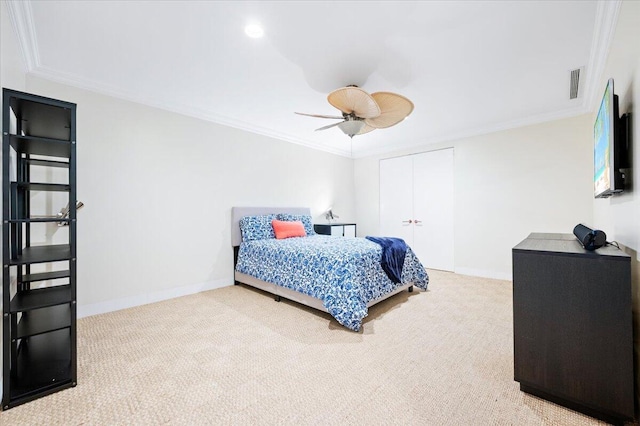 bedroom with carpet, a closet, ceiling fan, and ornamental molding