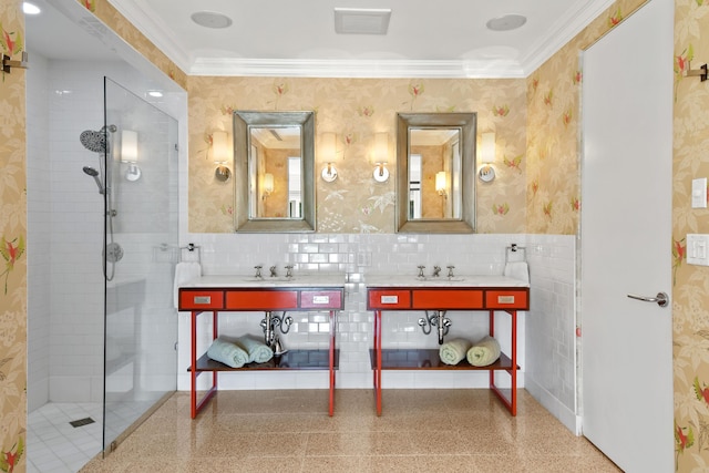 bathroom with a tile shower, vanity, and ornamental molding