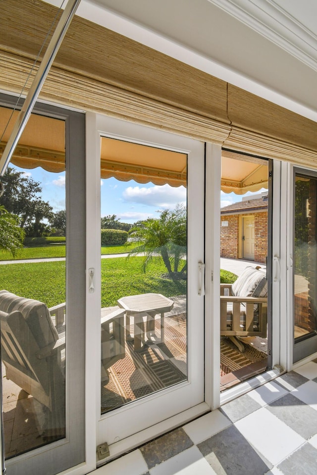 doorway to outside featuring crown molding