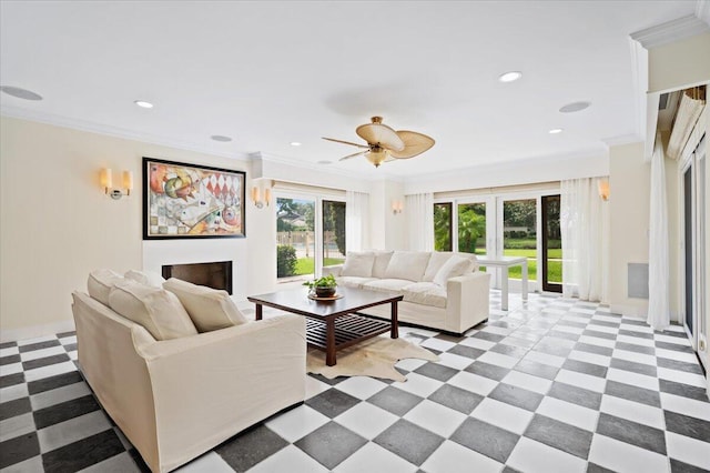 kitchen with ceiling fan, a kitchen bar, decorative backsplash, appliances with stainless steel finishes, and ornamental molding