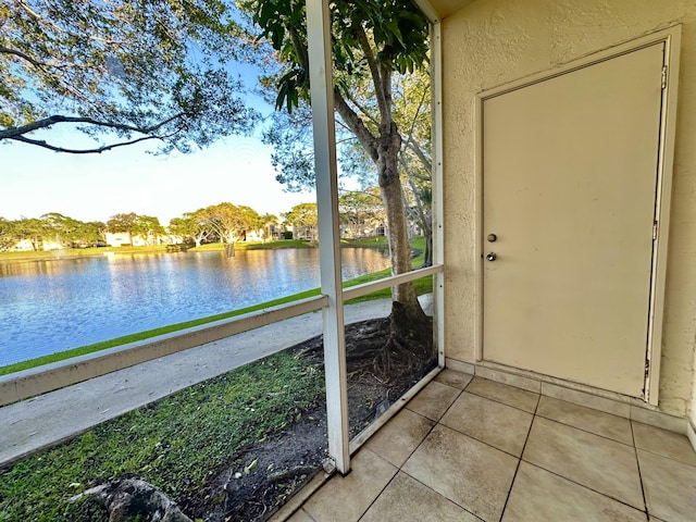 unfurnished sunroom with a water view