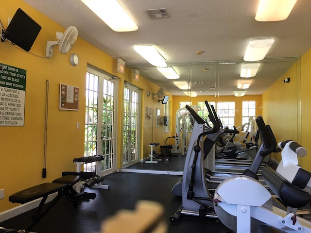 exercise room with a textured ceiling