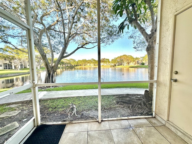 unfurnished sunroom with a water view