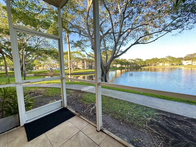 unfurnished sunroom featuring a water view