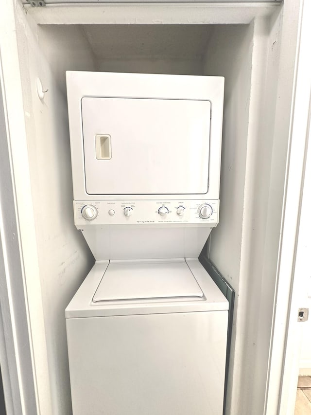 clothes washing area with stacked washer / drying machine