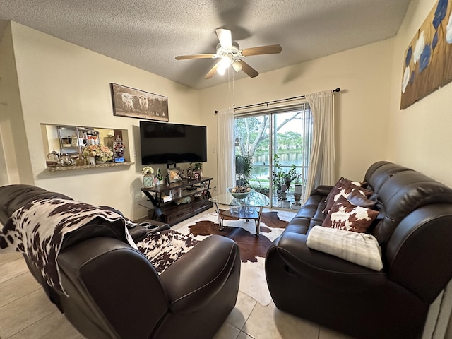 tiled living room featuring ceiling fan and a textured ceiling