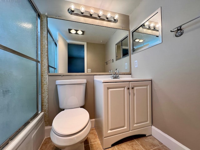 full bathroom with toilet, bath / shower combo with glass door, vanity, baseboards, and tile patterned floors