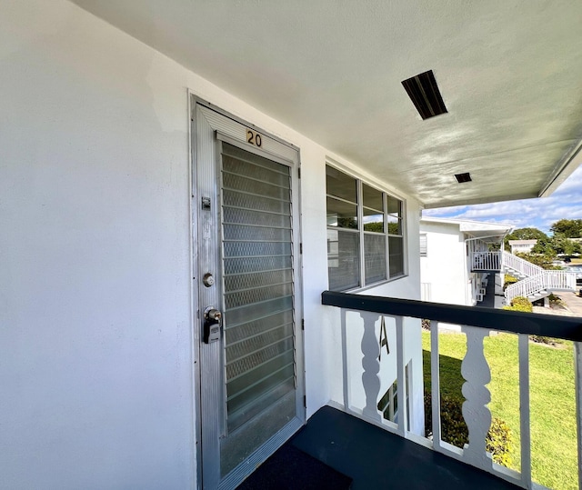 entrance to property with stucco siding