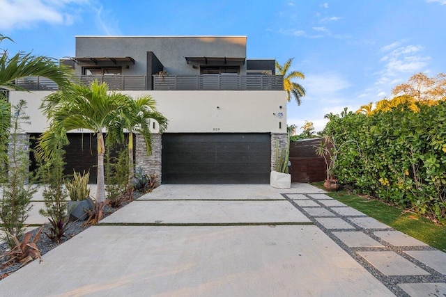 contemporary house with a balcony and a garage