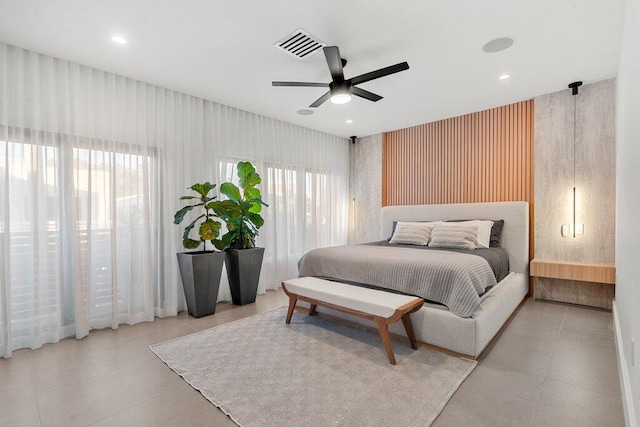 bedroom featuring multiple windows and ceiling fan