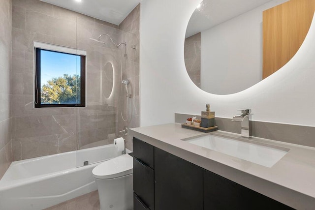 full bathroom with toilet, vanity, and tiled shower / bath