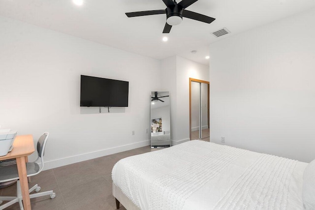 bedroom with a closet, tile patterned floors, and ceiling fan