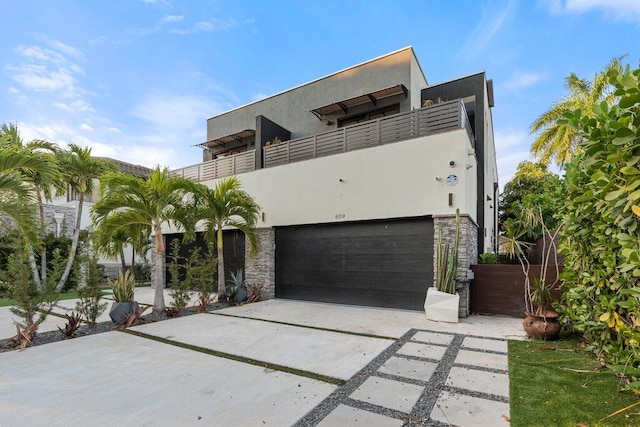 view of front facade featuring a balcony and a garage