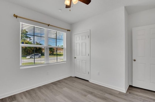 unfurnished room featuring ceiling fan and light wood-type flooring