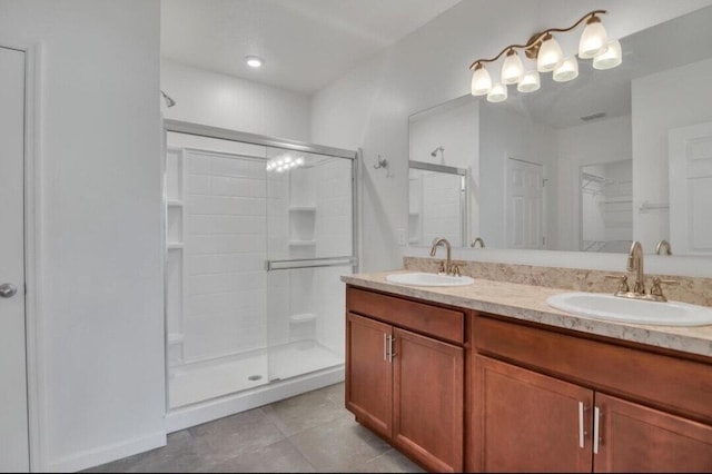 bathroom with tile patterned floors, vanity, and an enclosed shower