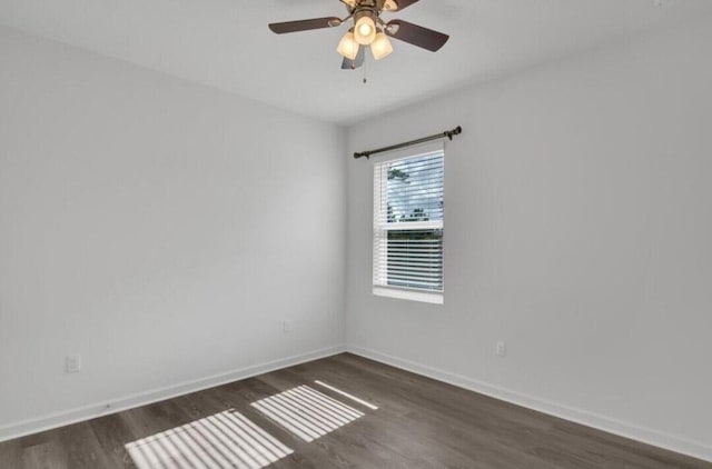 unfurnished room featuring ceiling fan and dark wood-type flooring