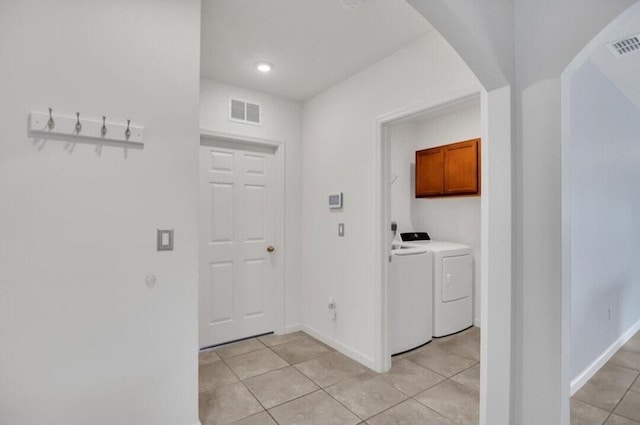 interior space featuring light tile patterned floors and washing machine and clothes dryer