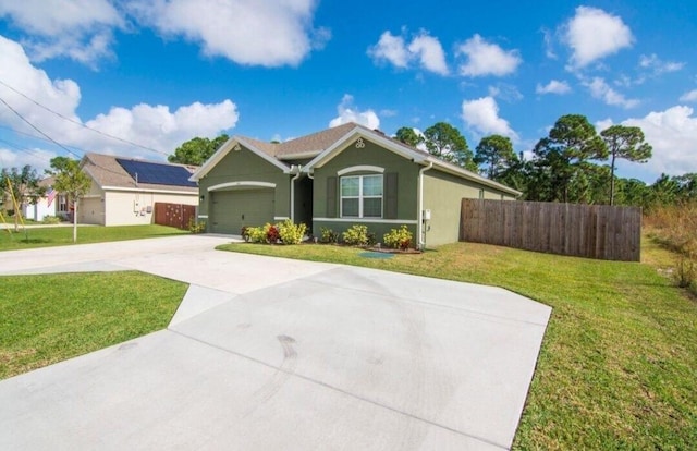 ranch-style house featuring a garage and a front yard