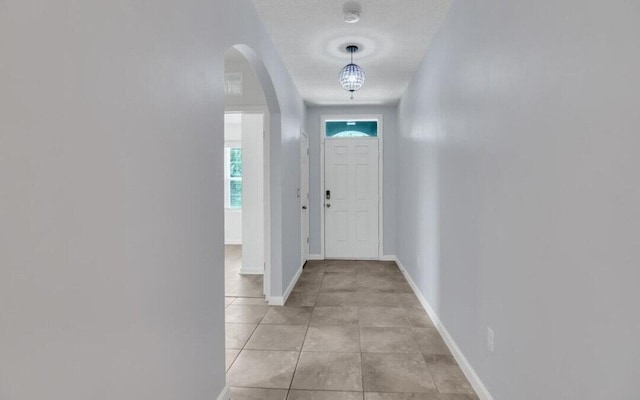 tiled foyer entrance with a textured ceiling