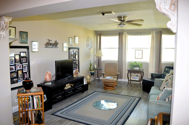 living room with ceiling fan and hardwood / wood-style flooring