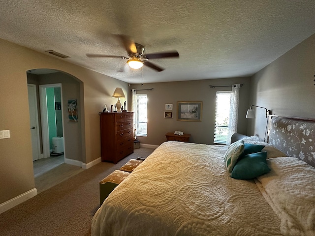 bedroom featuring carpet flooring, a textured ceiling, and ceiling fan