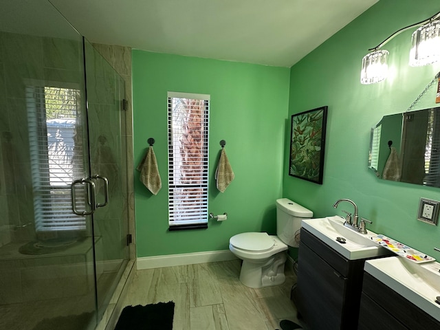 bathroom with plenty of natural light, vanity, an enclosed shower, and toilet