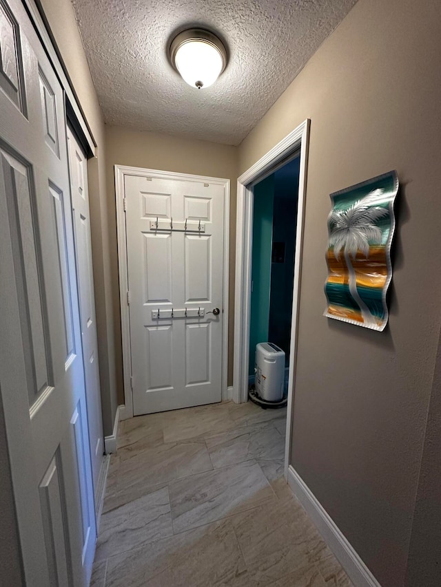 doorway featuring a textured ceiling