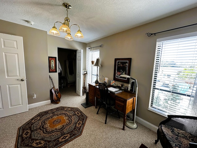 carpeted office featuring a textured ceiling and a notable chandelier