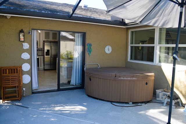 exterior space with a hot tub