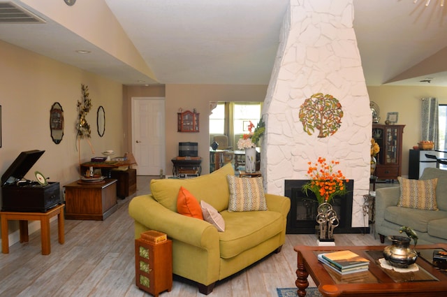 living room featuring vaulted ceiling and light wood-type flooring