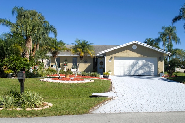 ranch-style home featuring a garage and a front yard