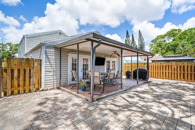 rear view of property featuring french doors and a patio