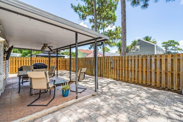 view of patio featuring ceiling fan and a grill