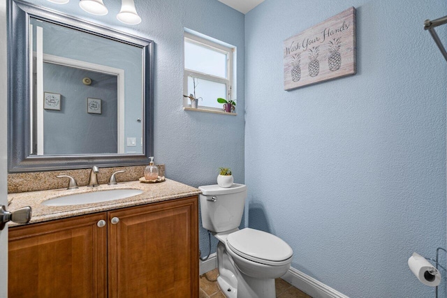 bathroom with tile patterned floors, vanity, and toilet