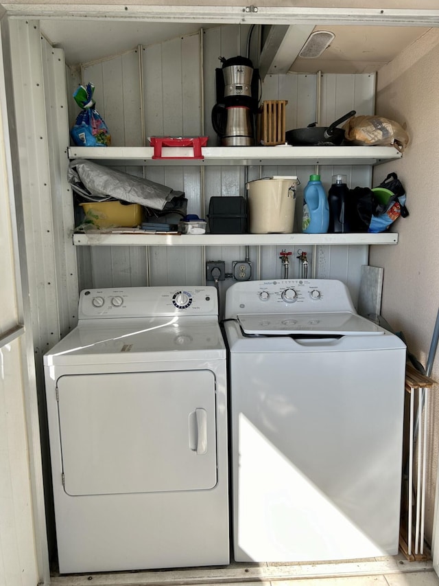 washroom with washing machine and clothes dryer