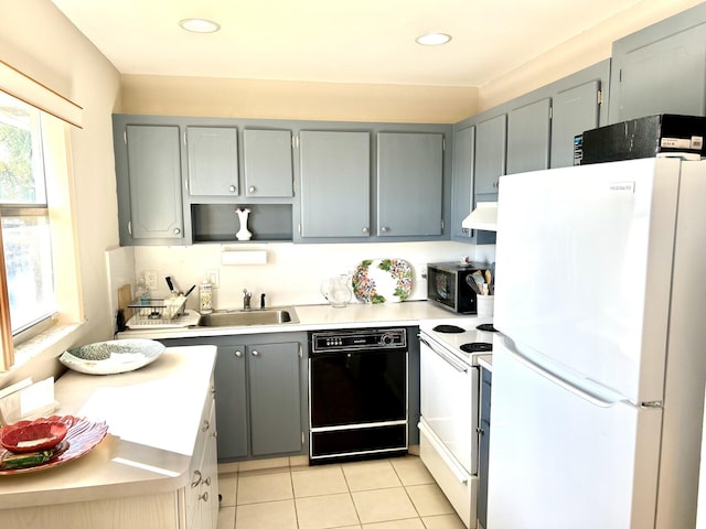 kitchen with gray cabinetry, sink, white appliances, light tile patterned floors, and exhaust hood