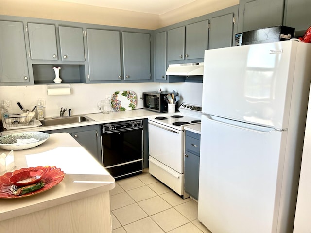 kitchen featuring light tile patterned floors, white appliances, gray cabinetry, and sink