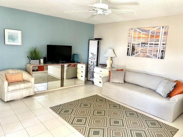 living room with light tile patterned floors, a textured ceiling, and ceiling fan