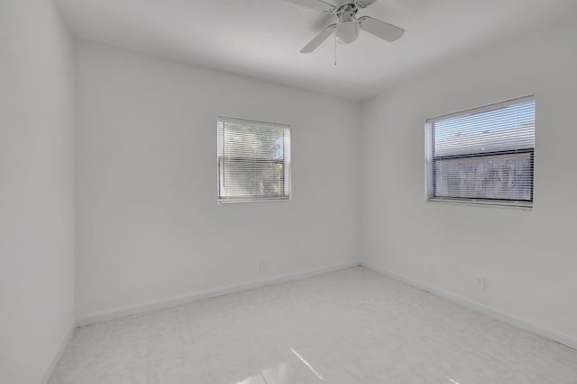 spare room with ceiling fan and plenty of natural light