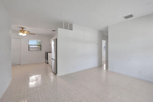 tiled empty room featuring ceiling fan