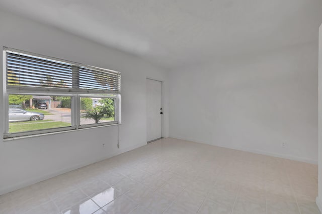 spare room with light tile patterned floors