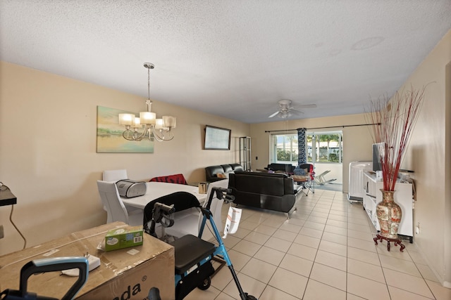 dining space featuring a textured ceiling, light tile patterned floors, and ceiling fan with notable chandelier