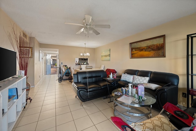 tiled living room with ceiling fan with notable chandelier