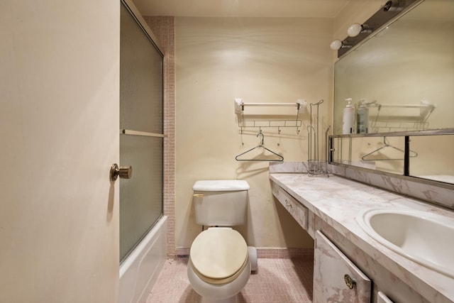 full bathroom featuring shower / bath combination with glass door, tile patterned flooring, vanity, and toilet