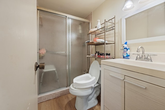 bathroom featuring hardwood / wood-style floors, vanity, toilet, and walk in shower