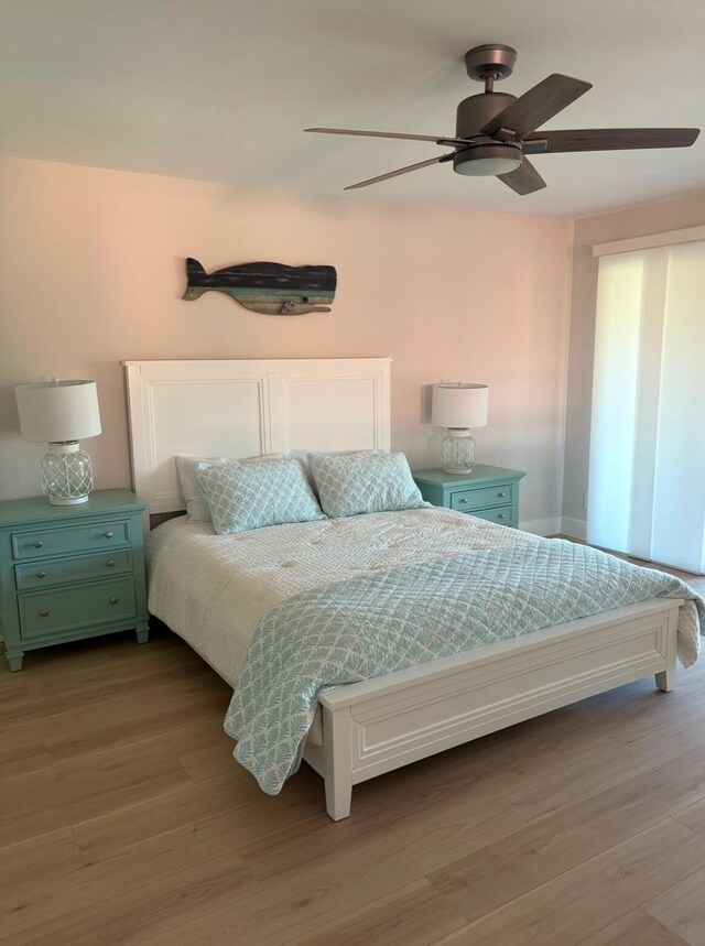 bedroom with ceiling fan, light hardwood / wood-style floors, and a closet