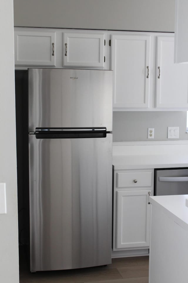 kitchen featuring white cabinets, dark hardwood / wood-style floors, and stainless steel appliances