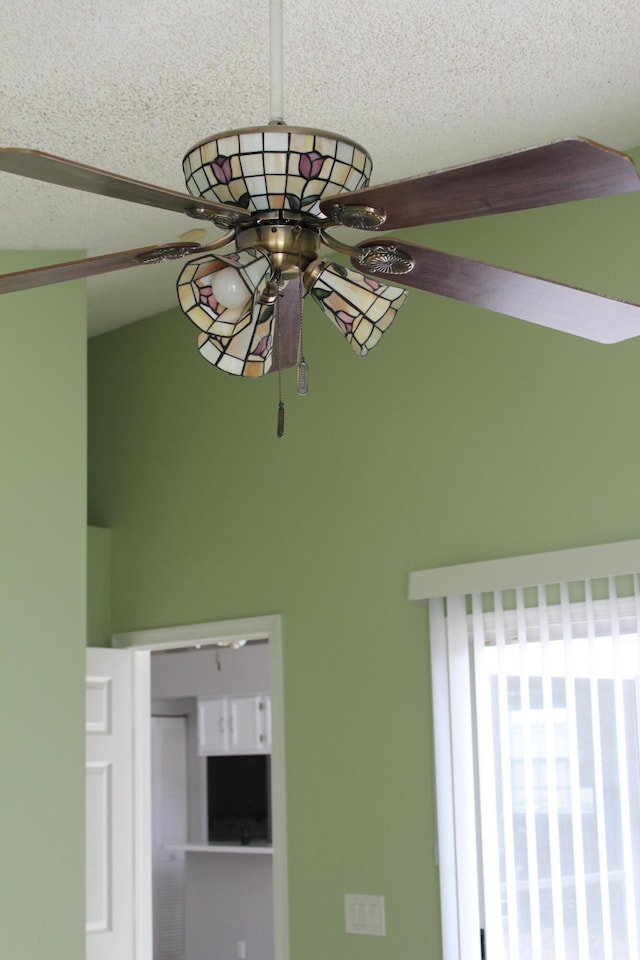 interior details featuring ceiling fan and a textured ceiling