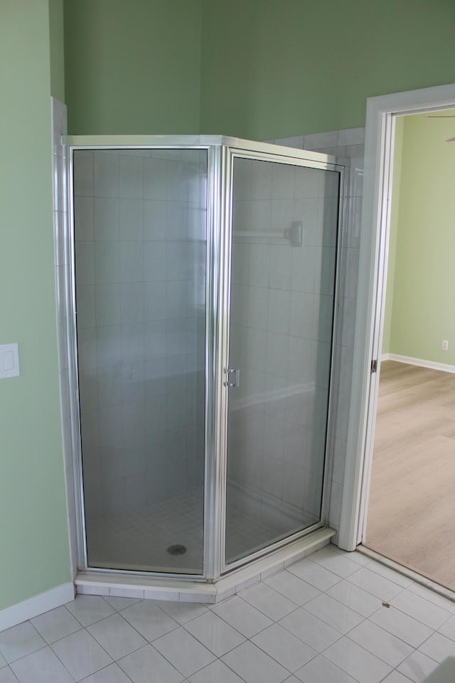 bathroom featuring hardwood / wood-style floors and walk in shower